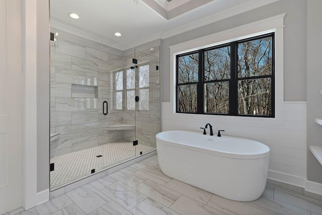 bathroom with crown molding and separate shower and tub