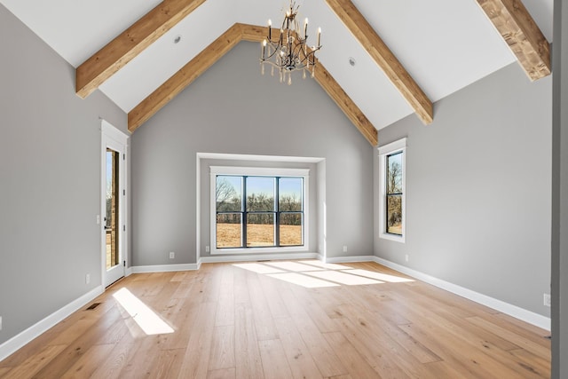 unfurnished living room with a chandelier, light hardwood / wood-style floors, high vaulted ceiling, and beamed ceiling