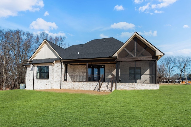 rear view of property with a lawn