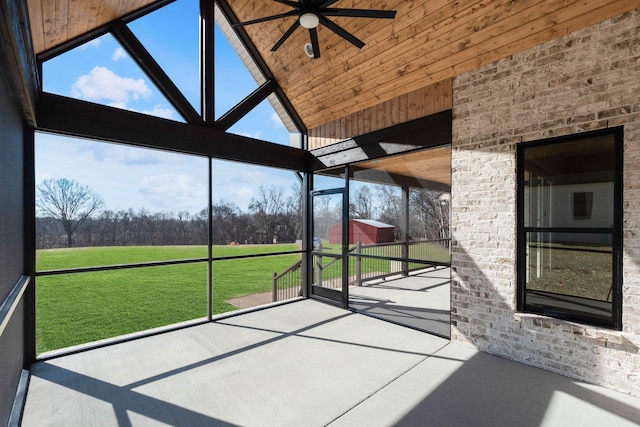 unfurnished sunroom featuring lofted ceiling and ceiling fan