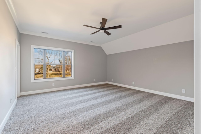 unfurnished room featuring crown molding, ceiling fan, carpet flooring, and vaulted ceiling