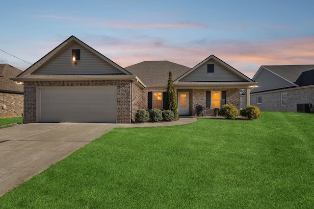 single story home with a lawn, cooling unit, and a garage