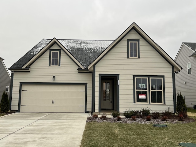 view of front of home with a front yard and a garage