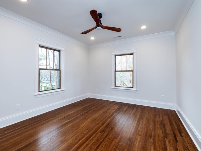 empty room with ornamental molding, ceiling fan, and dark wood-type flooring