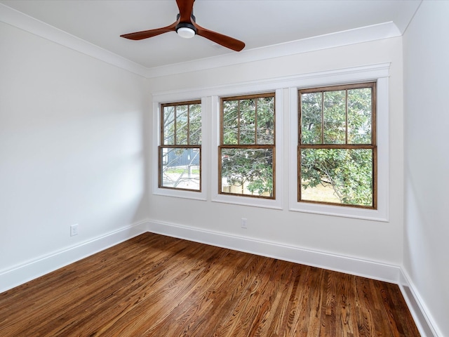 empty room with hardwood / wood-style flooring, ceiling fan, a healthy amount of sunlight, and ornamental molding