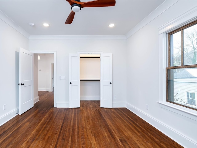 unfurnished bedroom featuring ceiling fan, dark hardwood / wood-style floors, ornamental molding, and a closet