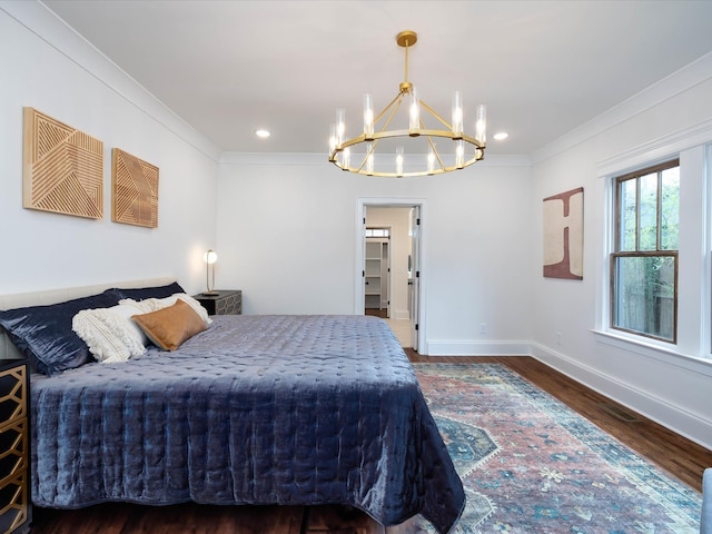 bedroom with dark hardwood / wood-style floors, a notable chandelier, and ornamental molding