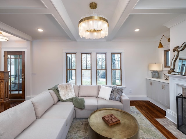 living room featuring crown molding, beamed ceiling, dark hardwood / wood-style floors, and a notable chandelier