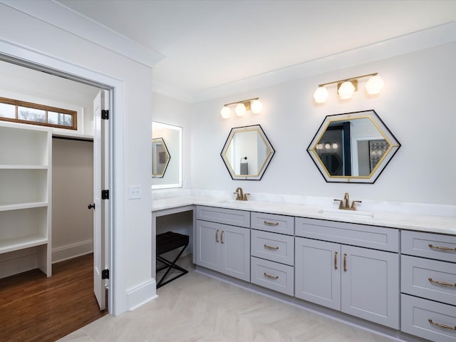 bathroom featuring crown molding, vanity, and wood-type flooring