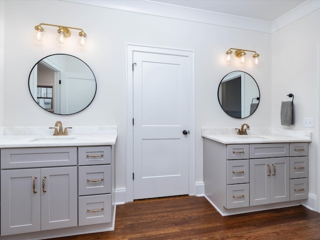 bathroom featuring hardwood / wood-style flooring, vanity, and crown molding