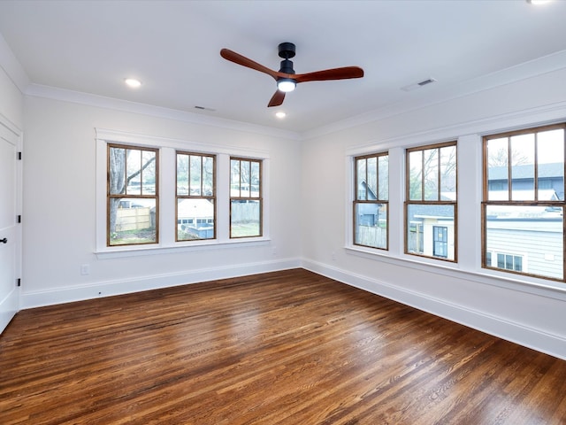 spare room with ceiling fan, crown molding, and dark wood-type flooring