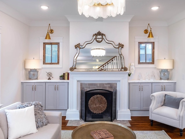 sitting room featuring dark hardwood / wood-style floors, a wealth of natural light, and ornamental molding