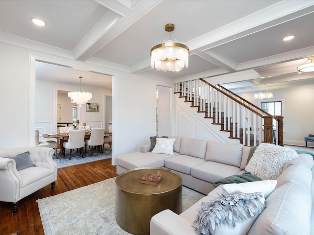 living room featuring a chandelier, beam ceiling, ornamental molding, and dark wood-type flooring