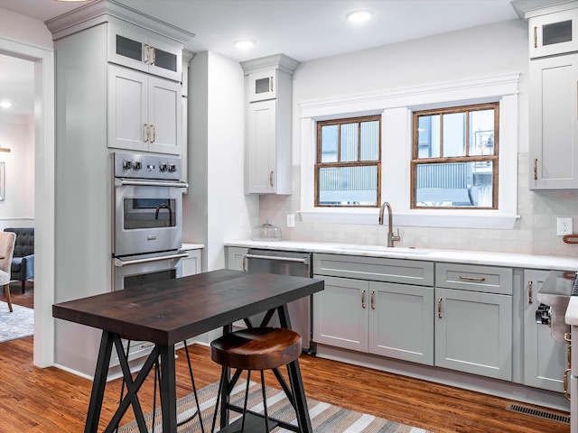 kitchen featuring gray cabinetry, decorative backsplash, plenty of natural light, and stainless steel appliances