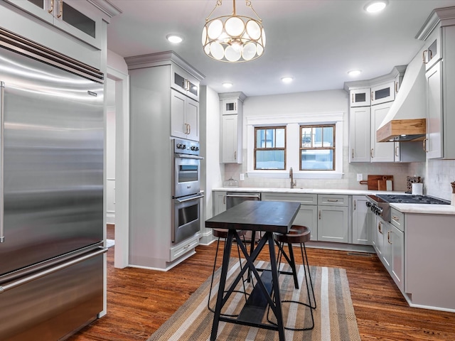 kitchen featuring decorative light fixtures, dark hardwood / wood-style flooring, stainless steel appliances, and tasteful backsplash