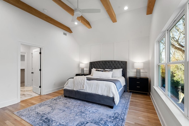 bedroom with wood-type flooring, vaulted ceiling with beams, and ceiling fan