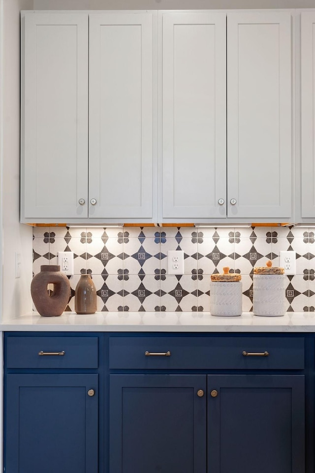 interior space with white cabinetry and tasteful backsplash