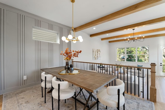 dining room with beam ceiling and a notable chandelier