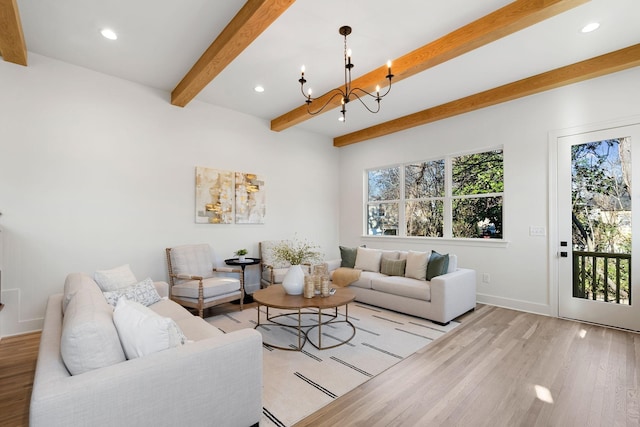 living room with beam ceiling, light wood-type flooring, and a notable chandelier