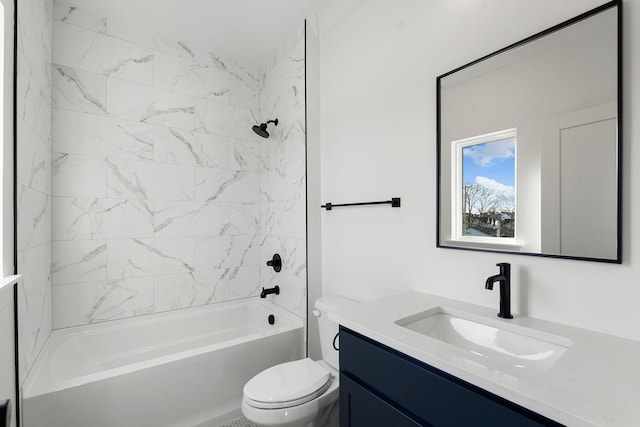 full bathroom featuring vanity, tiled shower / bath combo, and toilet