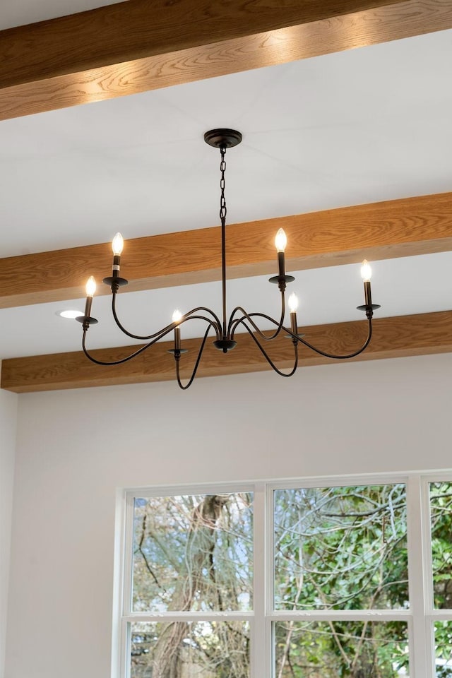 room details with beamed ceiling and a chandelier