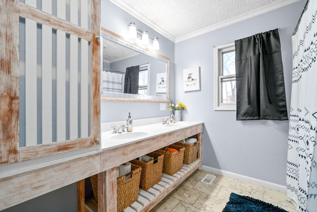 bathroom with vanity, a textured ceiling, and ornamental molding