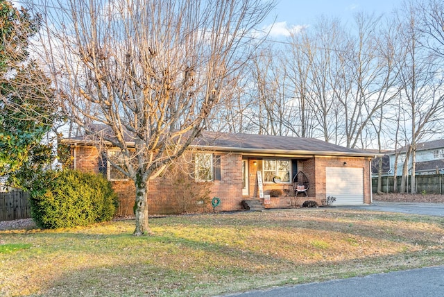 ranch-style house featuring a garage and a front lawn