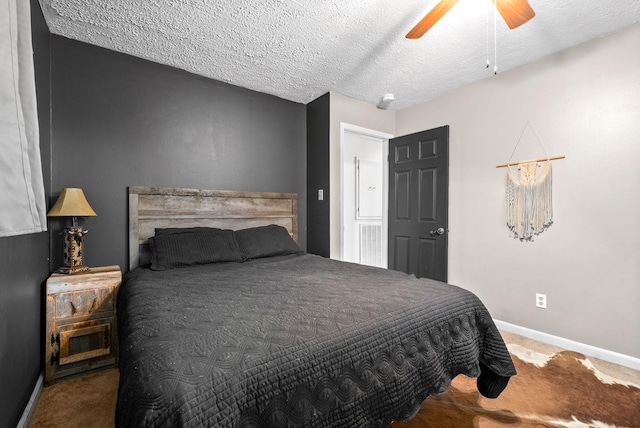 bedroom with ceiling fan, carpet floors, and a textured ceiling