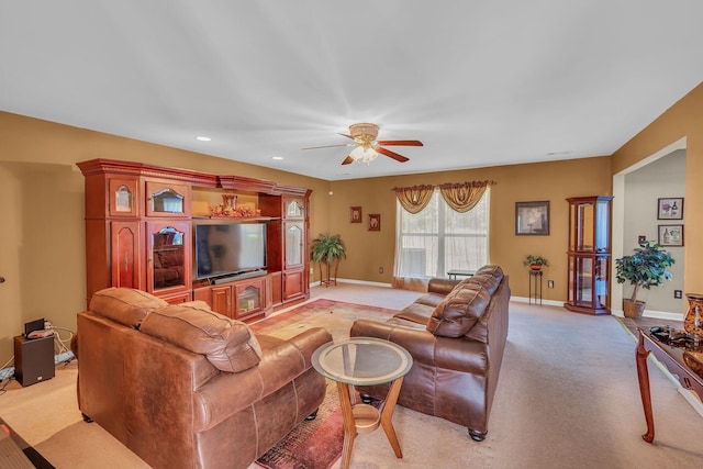 living room with ceiling fan and light colored carpet