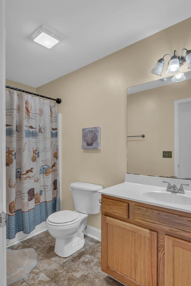 full bathroom featuring shower / bath combo, vanity, and toilet