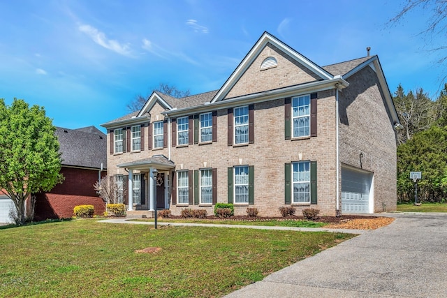 view of front of house with a garage and a front lawn