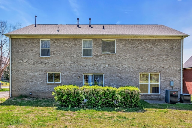 rear view of house featuring a yard