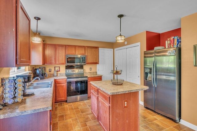 kitchen with appliances with stainless steel finishes, a kitchen island, hanging light fixtures, and sink