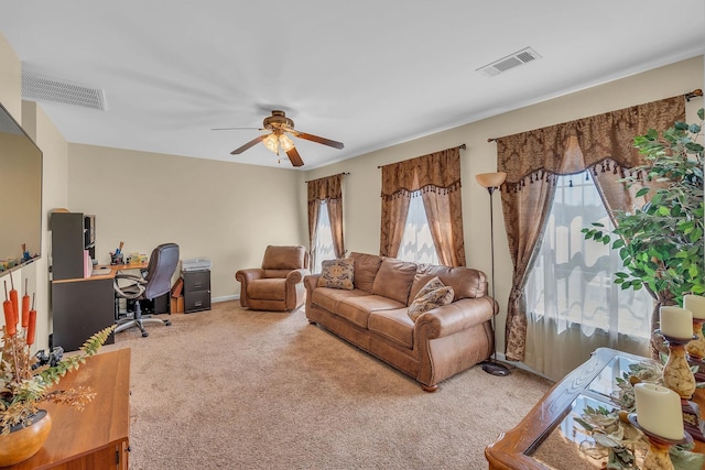 living room featuring carpet flooring and ceiling fan