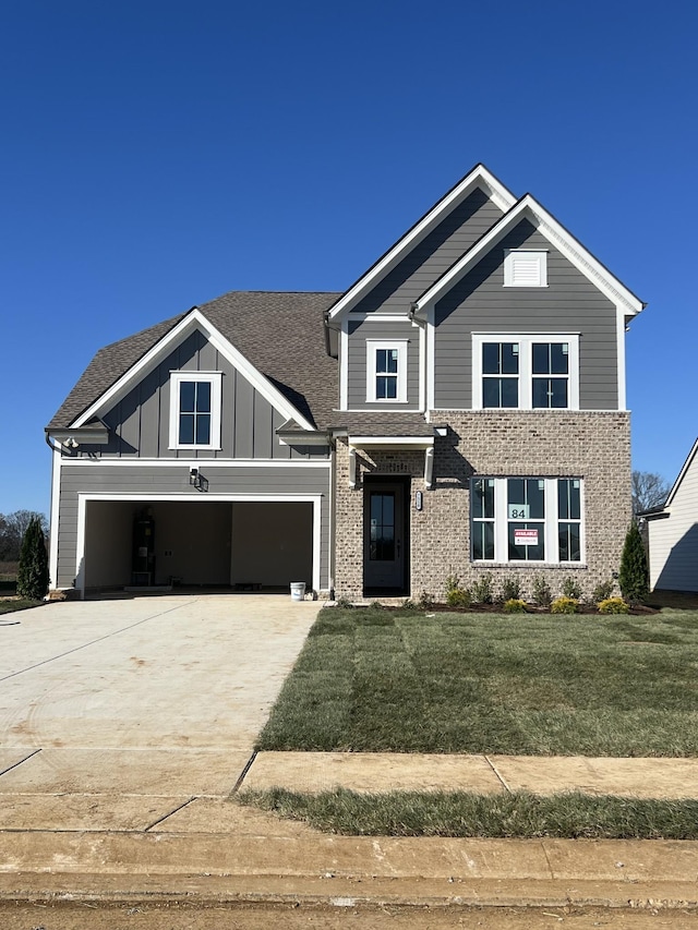 craftsman-style house featuring a garage and a front yard