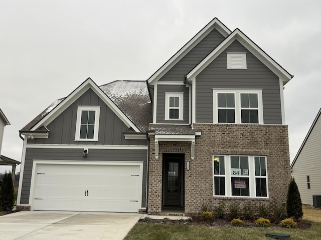 view of front of house featuring a garage and central air condition unit