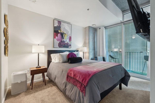 bedroom featuring a wall of windows, light carpet, and access to outside