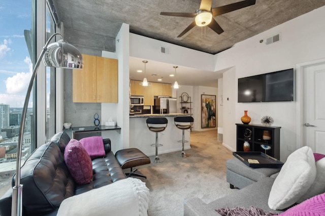 living room with ceiling fan and light carpet