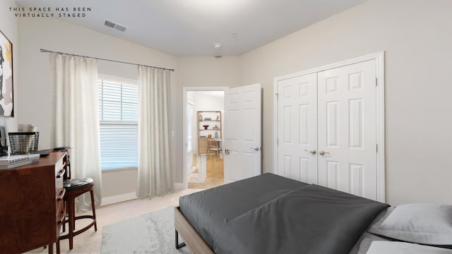 carpeted bedroom featuring a closet