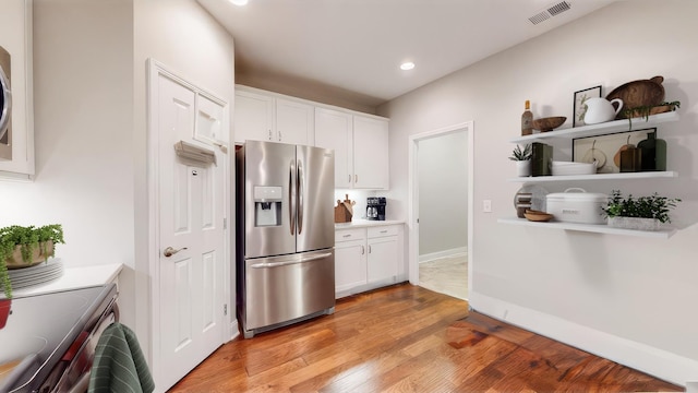 kitchen featuring white cabinetry, stainless steel appliances, and light hardwood / wood-style flooring