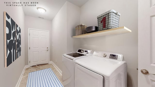 clothes washing area with washing machine and clothes dryer