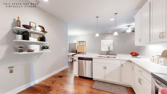 kitchen featuring sink, appliances with stainless steel finishes, white cabinetry, light hardwood / wood-style floors, and decorative light fixtures