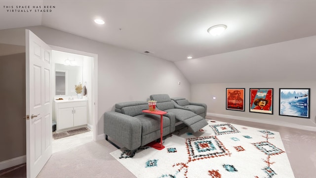 carpeted cinema room with vaulted ceiling