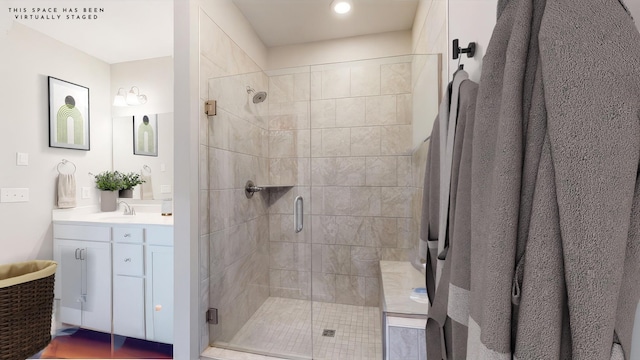 bathroom with an enclosed shower and vanity