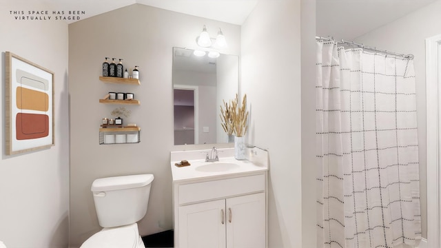 bathroom featuring vanity, a shower with curtain, and toilet