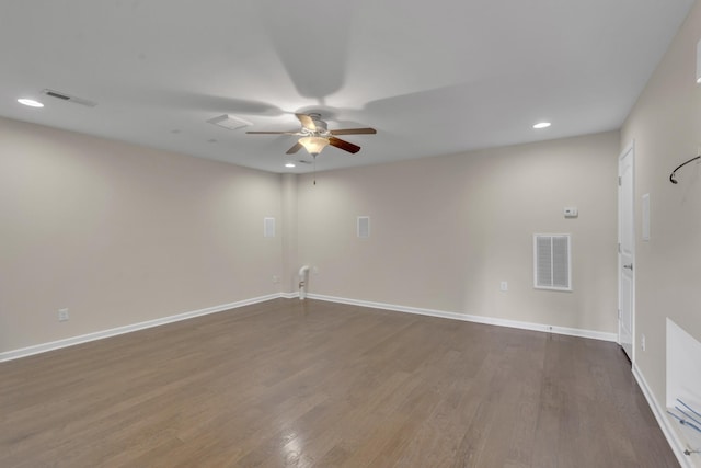 spare room with ceiling fan and dark hardwood / wood-style flooring