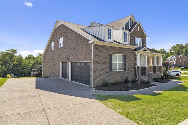 view of side of property featuring a garage and a yard