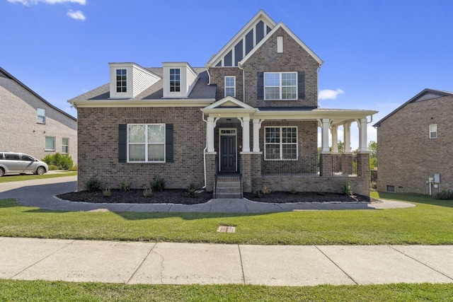 view of front of property featuring a porch and a front lawn