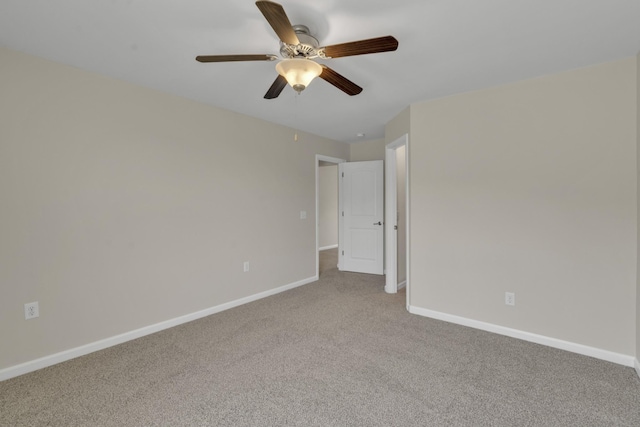 carpeted spare room with ceiling fan