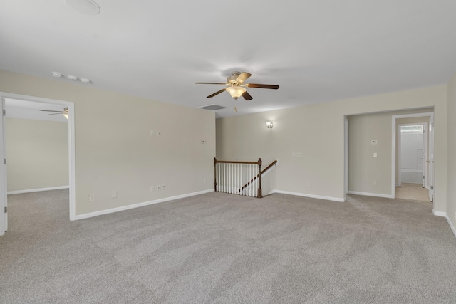 carpeted spare room with ceiling fan